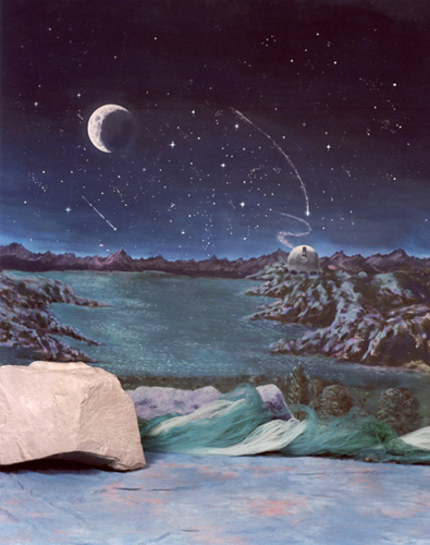 Surreal landscape with a crescent moon and a glowing orb over a rocky lake.