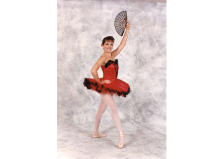 Ballet dancer in red tutu posing with a fan.