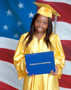 Graduate in gold cap and gown holding diploma in front of American flag.